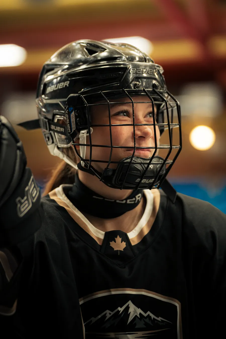 OFS player smiling in her helmet at the rink