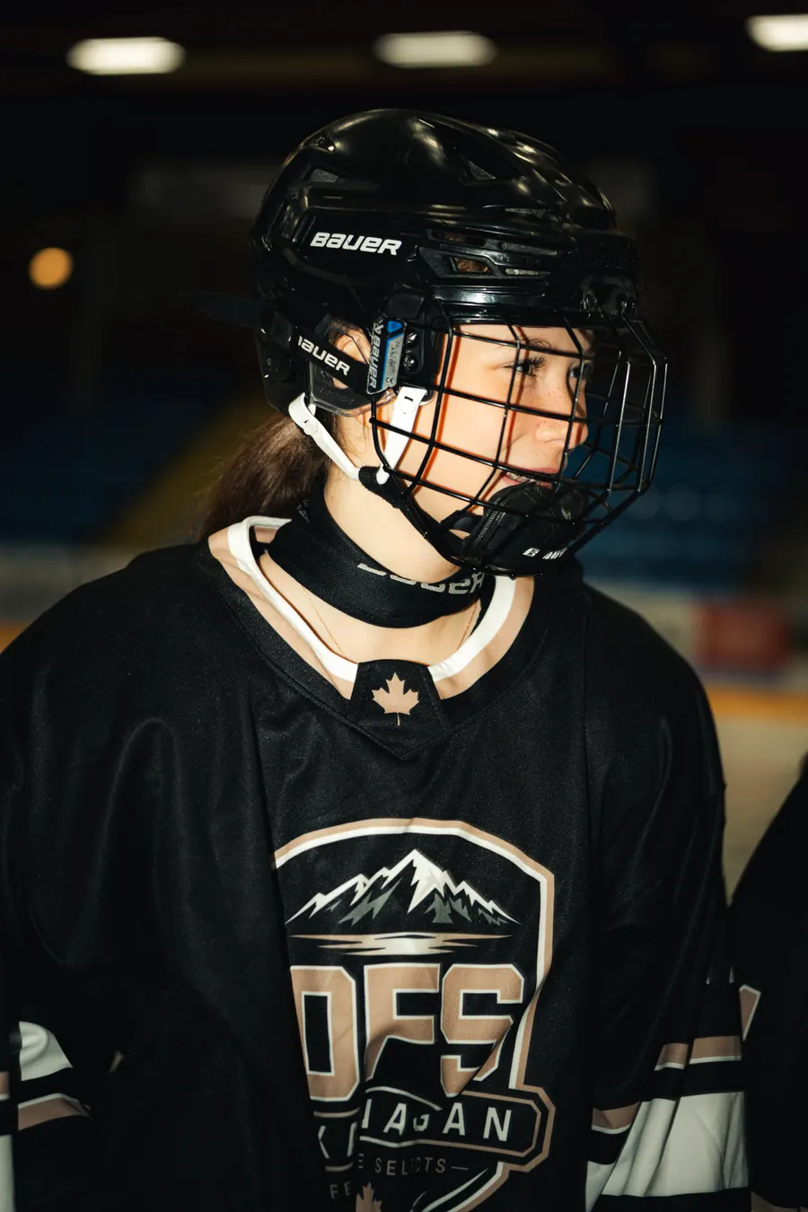 OFS player in her helmet and team jersey with the OFS crest